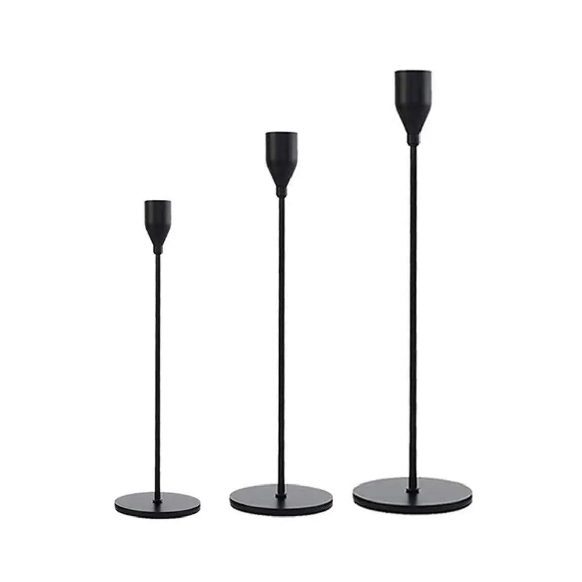 Elegant black candlestick holders in varying heights for a sophisticated home decor accent.