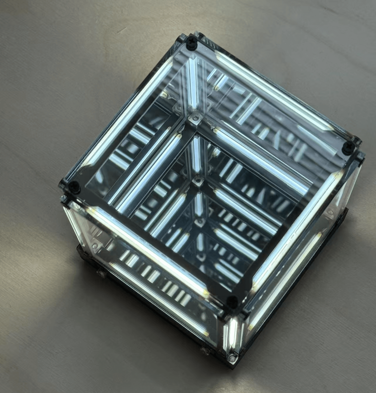 Cyberpunk ambient light featuring a cube design with reflective glass panels and glowing lights.