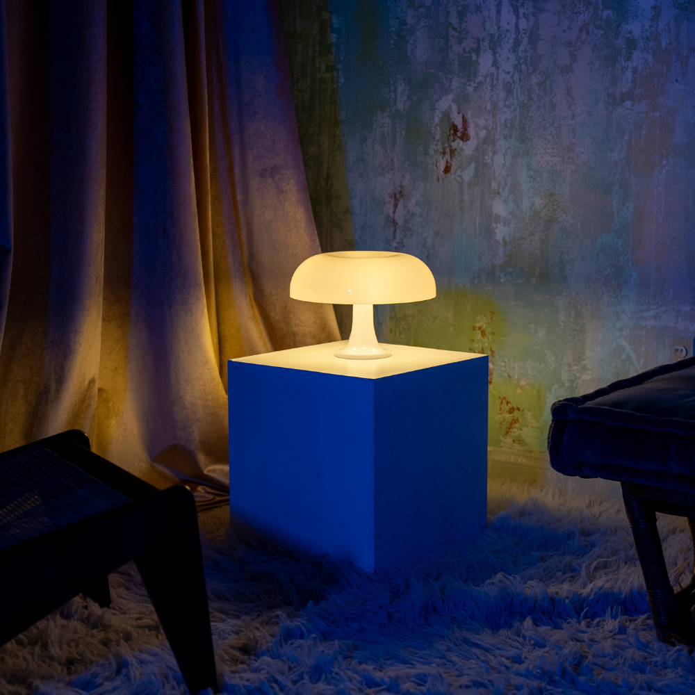 Lumiosa mushroom table lamp emitting a warm glow in a cozy living room setting, enhancing interior decor.