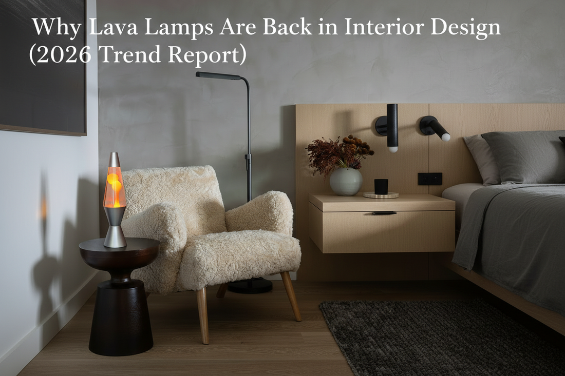 Glowing orange lava lamp on a dark side table beside a cream boucle armchair in a moody Scandinavian living room — 2026 interior design trend.