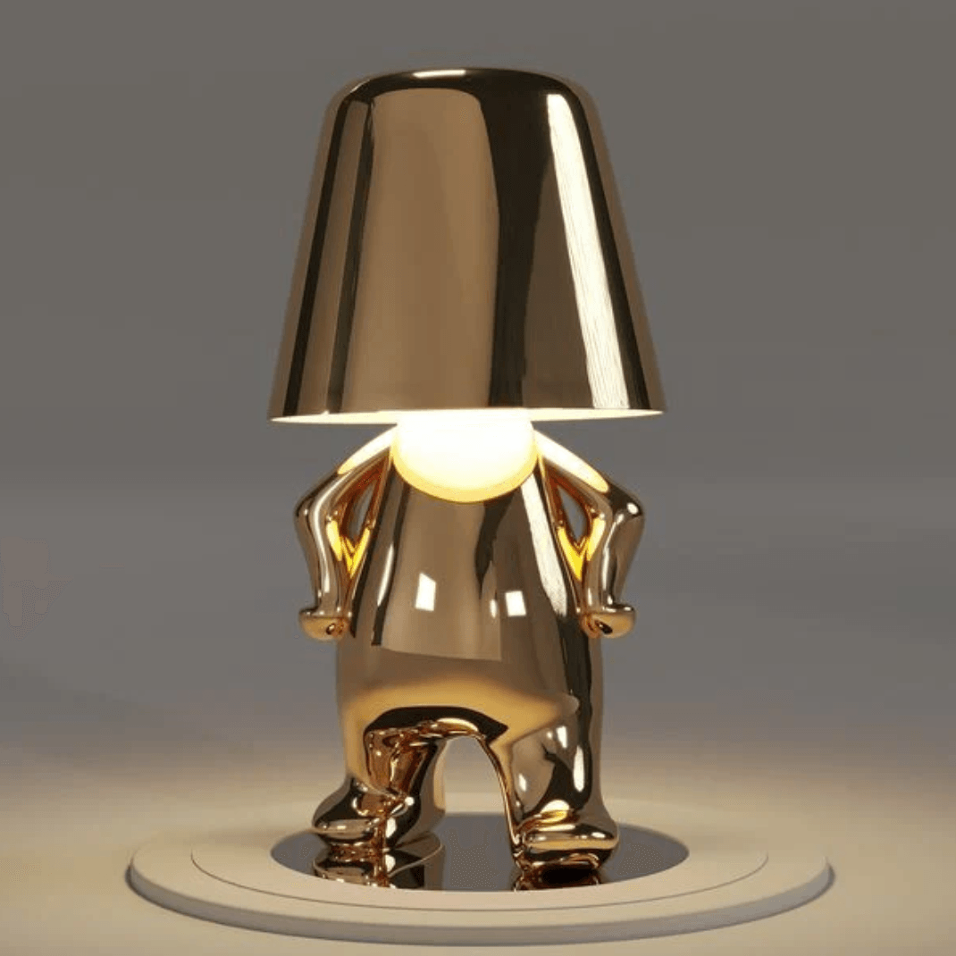 Thinker Brothers Table Lamp with a unique gold design, featuring a playful figure and elegant minimalist style.