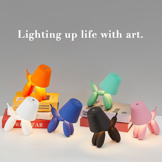 Pink Balloon Dog LED lamp on a bedside table