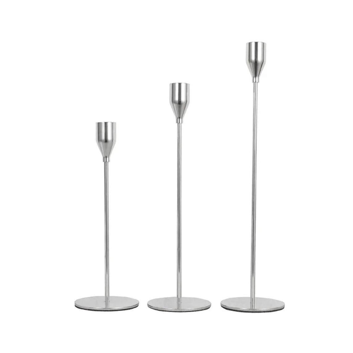 Elegant stainless steel candlestick holders in three heights, perfect for enhancing home decor and creating a warm ambiance.