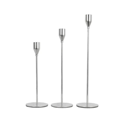 Elegant stainless steel candlestick holders in three heights, perfect for enhancing home decor and creating a warm ambiance.