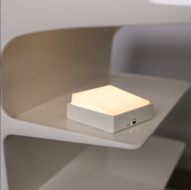 Switch-shaped nightlight on modern shelf, providing adjustable brightness for nighttime convenience.