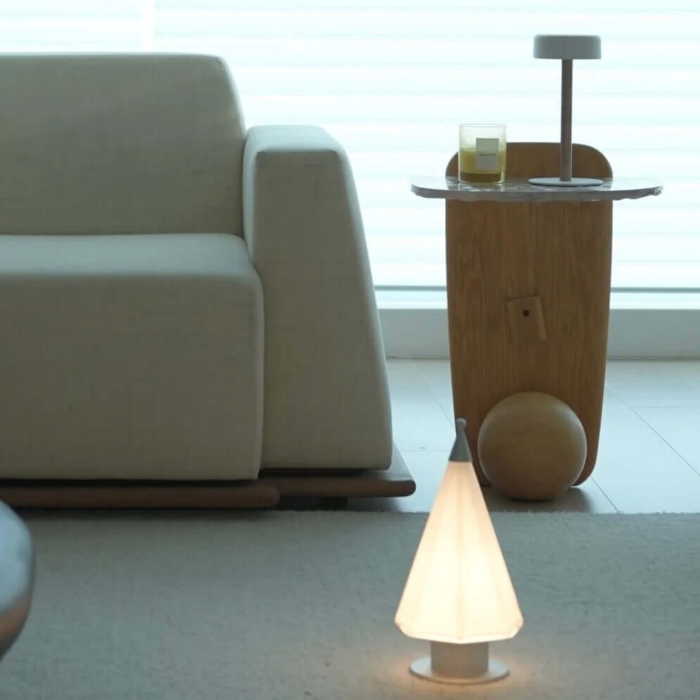 Cozy living room featuring a handcrafted cedar lamp with a fairy-tale glow next to a modern wooden side table.