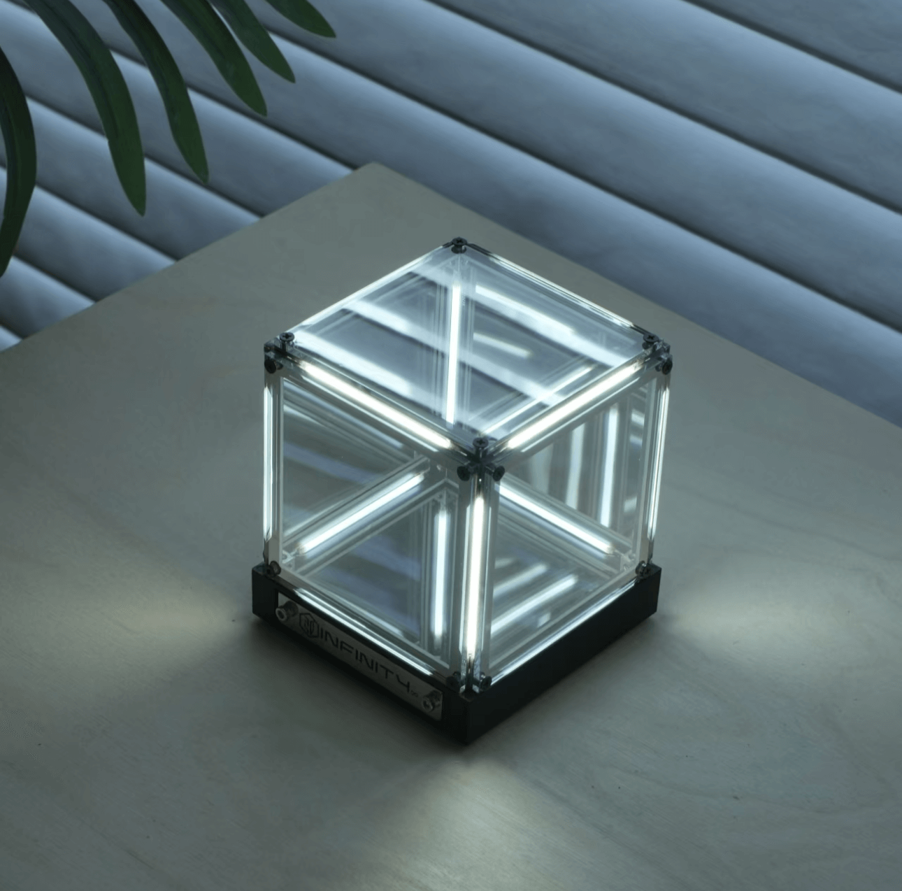 Cyberpunk ambient light cube on a wooden surface, showcasing glass panels and glowing LED design.