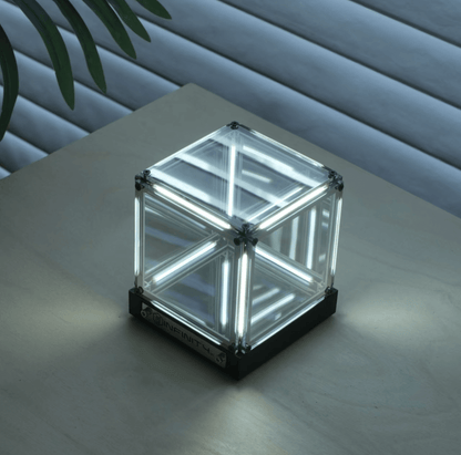 Cyberpunk ambient light cube on a wooden surface, showcasing glass panels and glowing LED design.