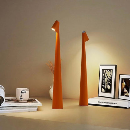 Stylish orange touch-control LED desk lamps illuminating a modern workspace with art and coffee cup.