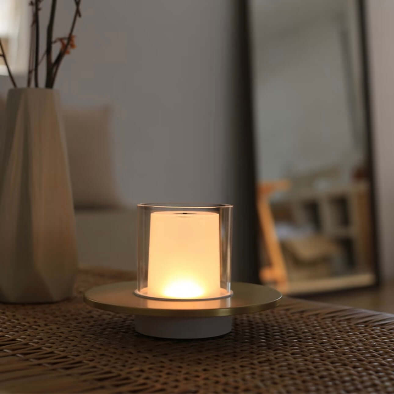 Rechargeable candle lamp on a table, emitting a soft warm glow for cozy ambiance.