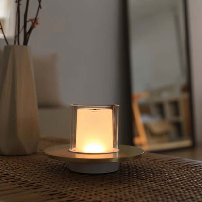 Rechargeable candle lamp on a table, emitting a soft warm glow for cozy ambiance.