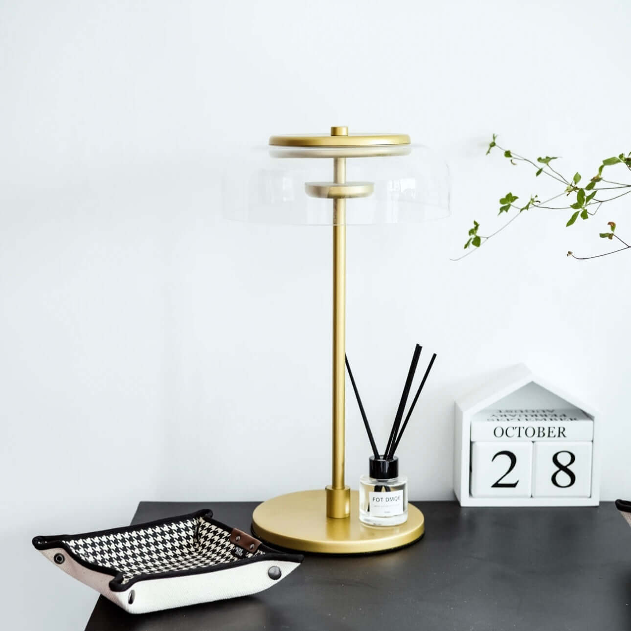 Vintage luxury table lamp with metal base and glass lampshade, stylishly placed on a modern desk.
