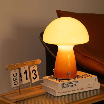 Stylish mushroom table lamp with a soft yellow glow, featuring an elegant glass shade and modern design.