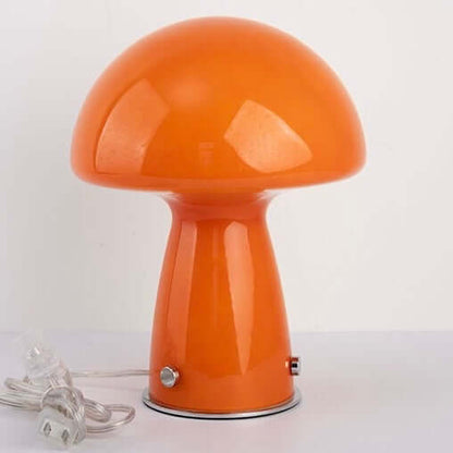 Orange mushroom table lamp with glossy glass shade, stylish design, perfect for any home decor.