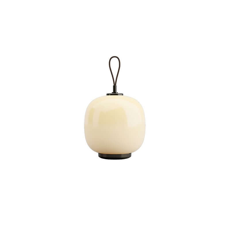 Danish portable table lamp in cream with black handle, showcasing vintage design and soft ambient light.