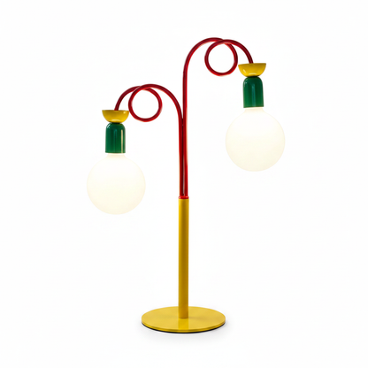 `Memphis style double-head table lamp with yellow base, red swirl arms, green sockets and frosted globe bulbs on white background`