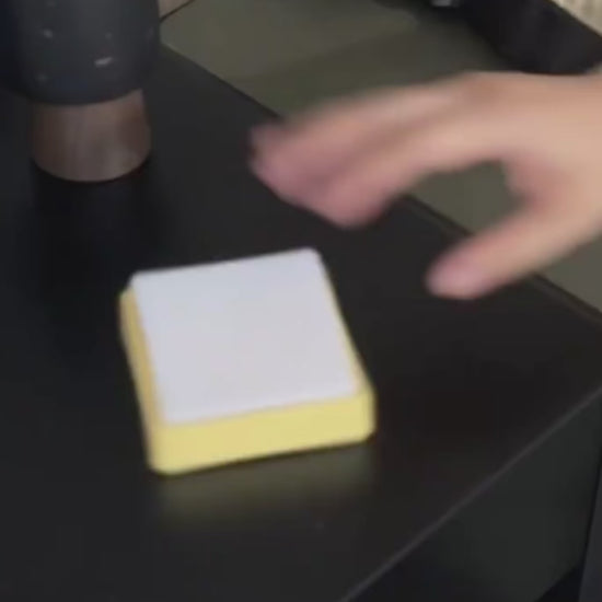 Person tapping a switch-shaped nightlight on a bedside table for adjustable lighting.