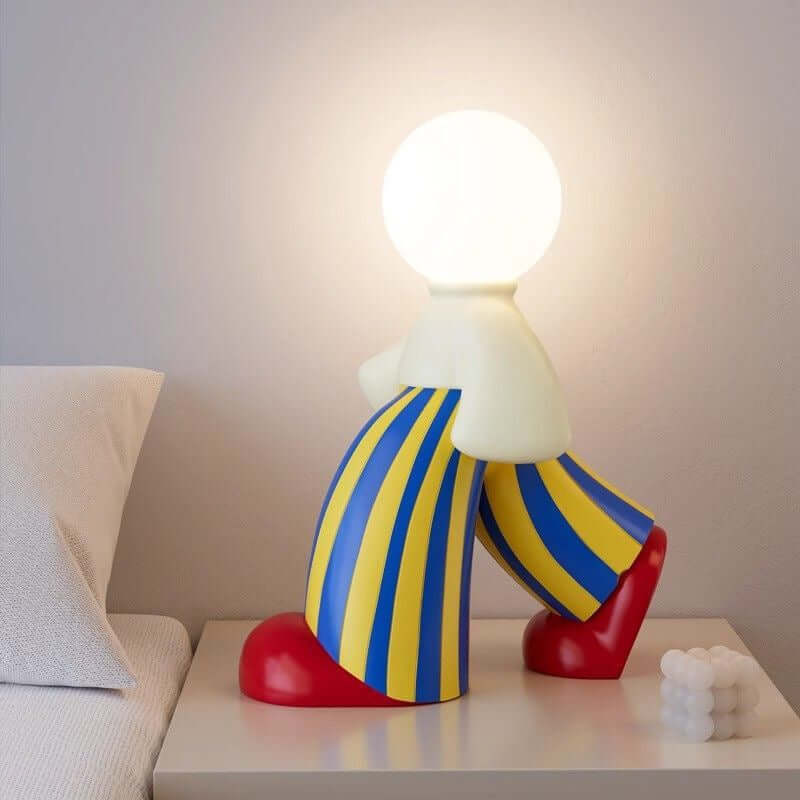 Art Figure Walking Man Lamp showing 3-color touch dimming effect on a modern desk